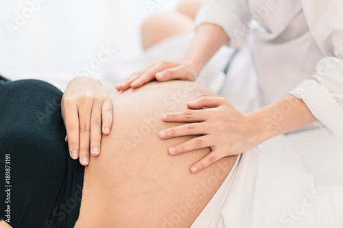 Female Obstetrician doctor Examination to a pregnant woman at hospital.