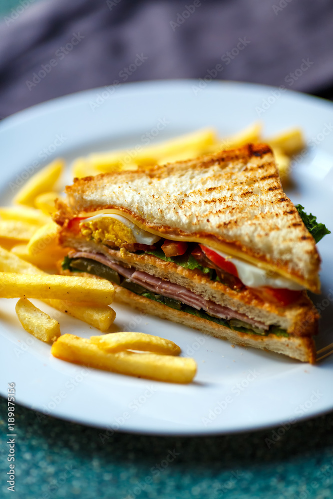 Delicious club sandwich with french fries at a diner. Delicious club sandwich with french fries at a diner.