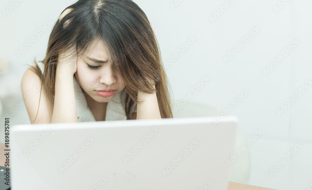 Selective focus tired young business woman with laptop computer, office syndrome concept. Selective focus tired young business woman with laptop computer, office syndrome concept.