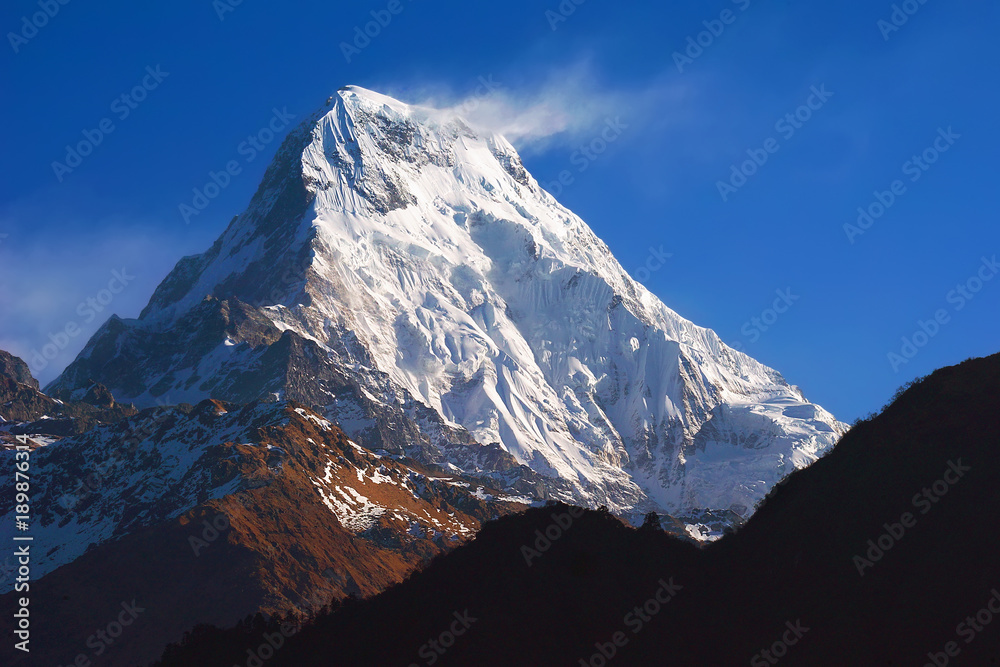 Annapurna South,  mountain view from famous Poon Hill viewpoint with blue sky background in the morning, on sunrise. Nepal landscape, Annapurna circuit, Himalaya Range, Asia. Horizontal view