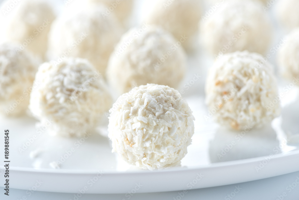 Coconut candies on white plate Coconut candies on white plate