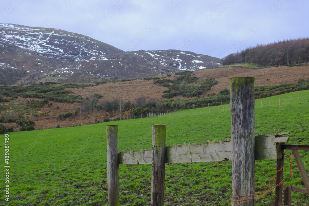 A view across on of the many snow topped hills and valleys of the Mourne Mountains on a dull midwinter afternoon 