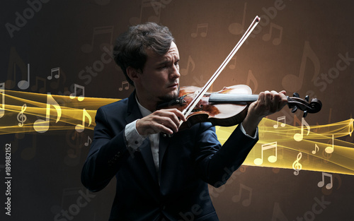 Musician playing on violin with notes around photo