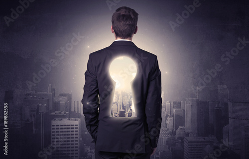 Businessman standing with keyhole on his back