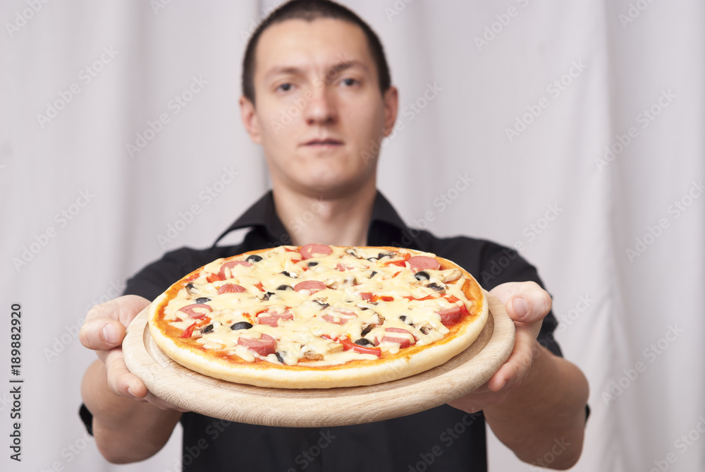 man holding a pizza