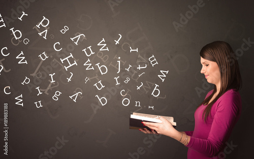 Young lady holding book with letters © ra2 studio