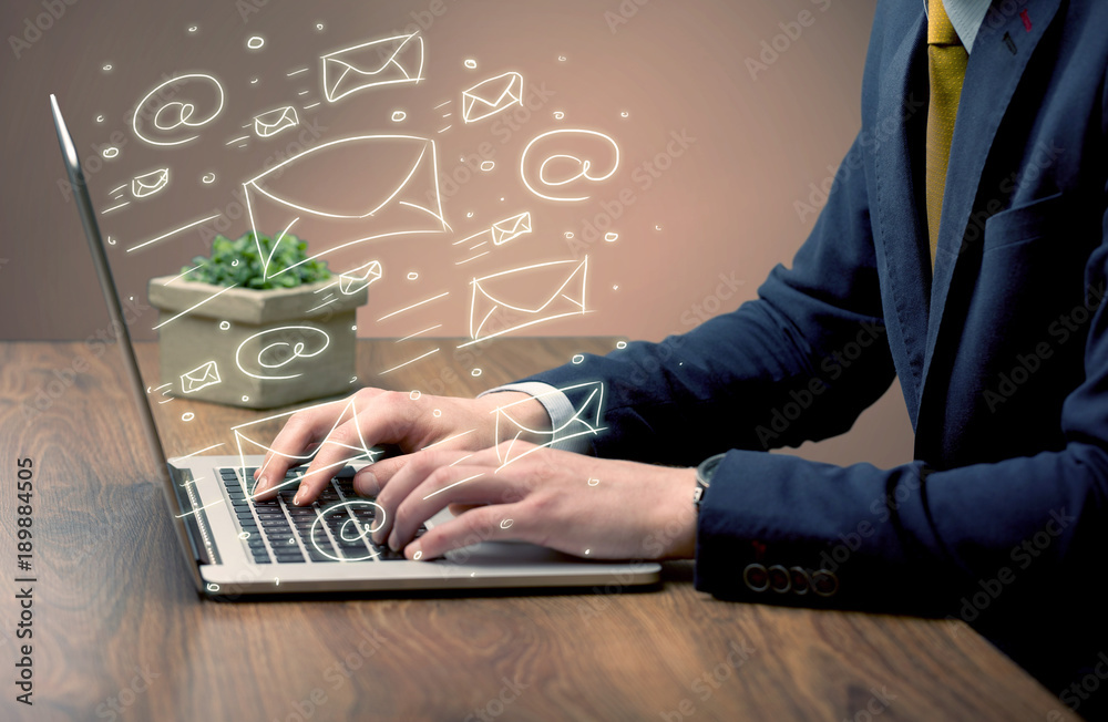 Sending client news letters on laptop Sending client news letters on laptop