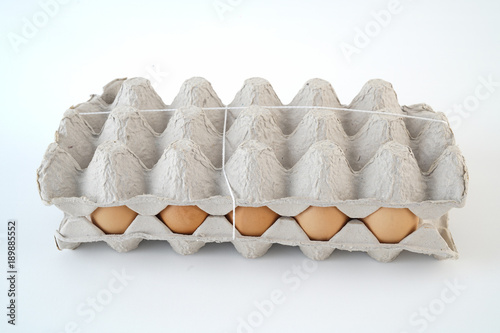 Fifteen yellow eggs ready to cook in the box