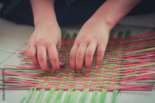 Closeup to hand of Thai students grade 4 in primary school are weaving pattern thai.