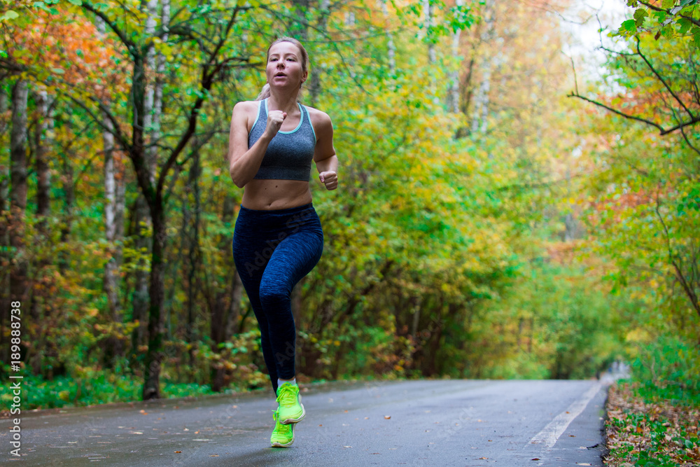 Woman running in the autumn park Woman running in the autumn park