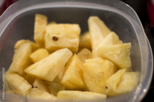 Sliced pineapple in plastic container