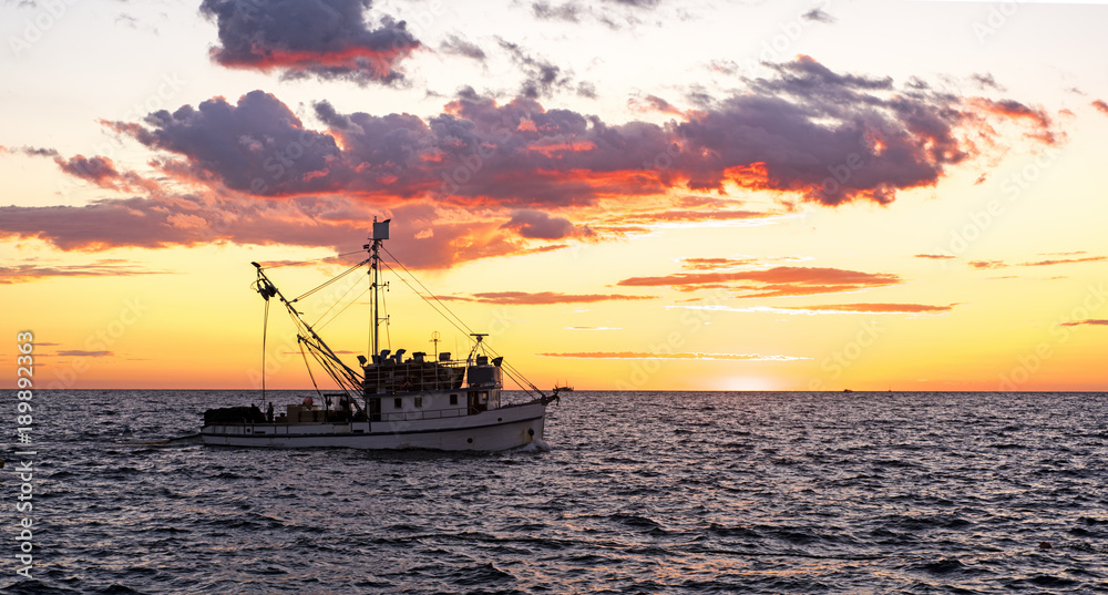 Small ship in sea. Summer day sunset.