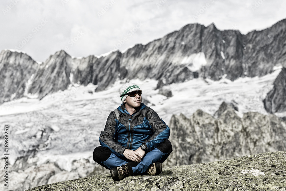 Alpinist enjoys the peace and solitude in the Swiss Alps Alpinist enjoys the peace and solitude in the Swiss Alps