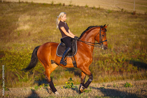 Young sportswoman on horse