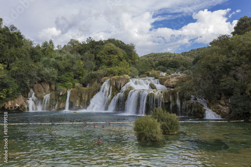 SIBENIK, CROATIA: Day view of Krka waterfalls in the natual park, with people bathing in the lake