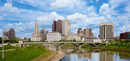 Beautiful skyline of Columbus Ohio with bridge and water reflection photo