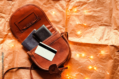 a leather bag with a passport and a credit card. journey. view from above