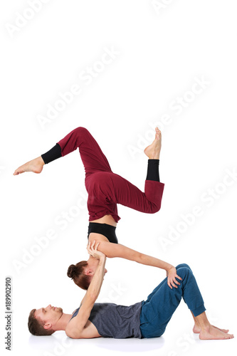 Young athletic couple practicing acroyoga. Balancing in pair © lenets_tan