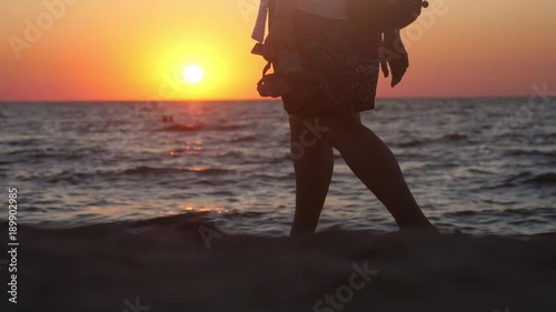 close up of Young family walking on beach with child at amazing sunset. slow motion. 1920x1080 photo