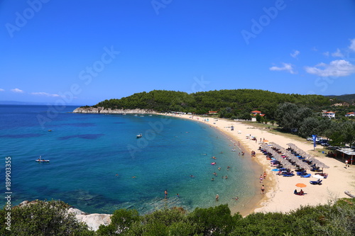 Fototapeta Naklejka Na Ścianę i Meble -  Panoramic view of the lagoon with vacationers. Blue water and umbrellas from the sun