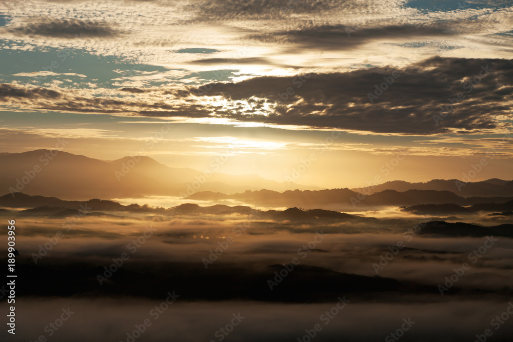 Beautiful scenery sunlight in the morning sunrise above flowing fog waves on mountain tropical rainforest in phang nga thailand.