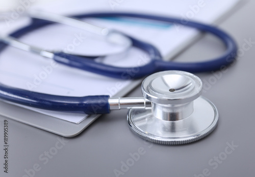 Medical equipment: blue stethoscope and tablet on white background. Medical equipment photo