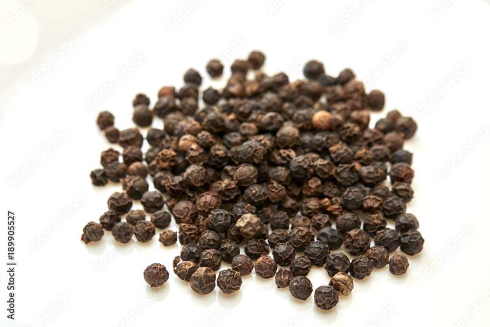 black peppers on white background black peppers on white background