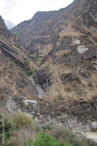 The torrential flow through the hills in Tibet photo