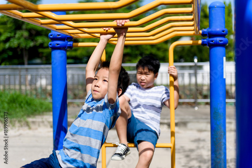 Young asian boy hang out door playground
