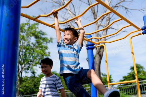 Young asian boy hang  out door playground