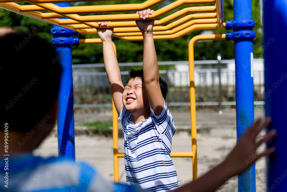 Fototapeta premium Young asian boy hang out door playground