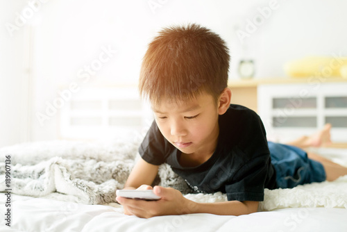 Young Asian boy play game on smartphone