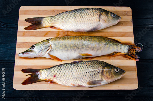 Uncooked fish on cutting board in meal preparation concept