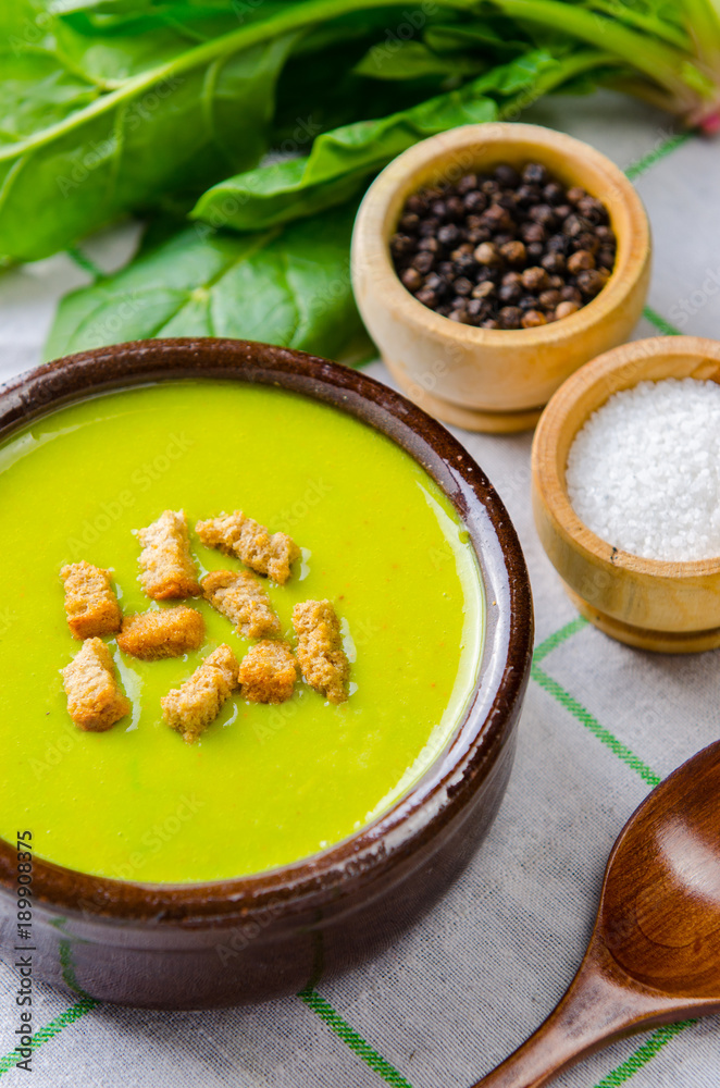 Spinach soup served on wooden board Spinach soup served on wooden board