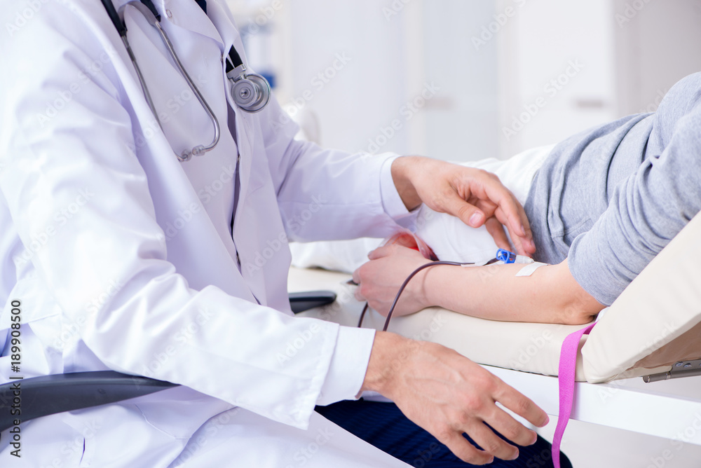 Patient getting blood transfusion in hospital clinic Patient getting blood transfusion in hospital clinic