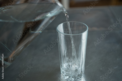 pouring water from a pitcher into a glass