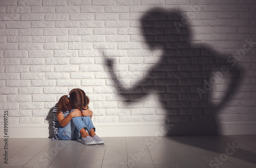Konstfotografi domestic violence. angry mother scolds   frightened daughter .