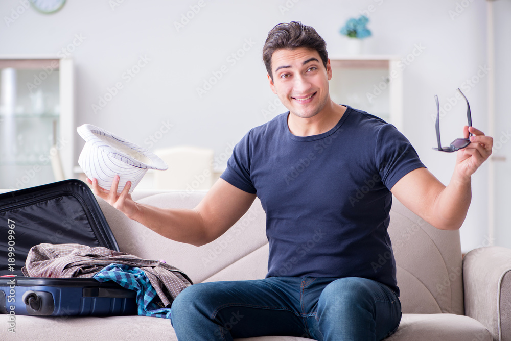 Man with hat preparing for summer vacation Man with hat preparing for summer vacation