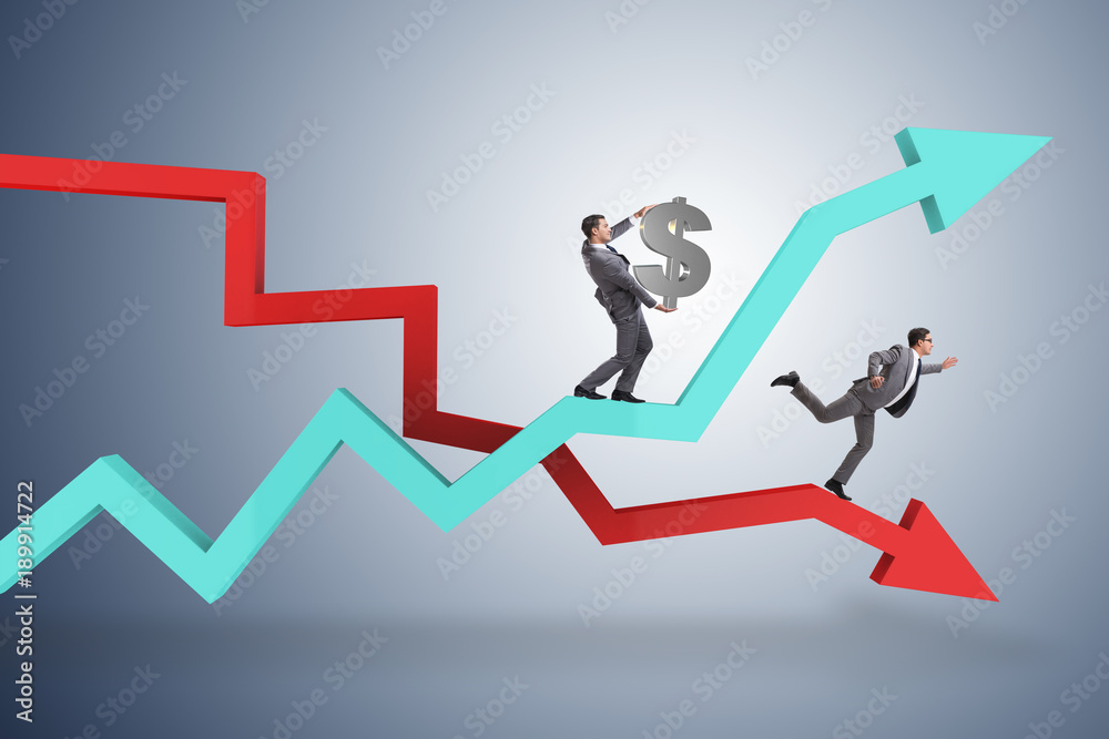 Businessman with charts of growth and decline Businessman with charts of growth and decline