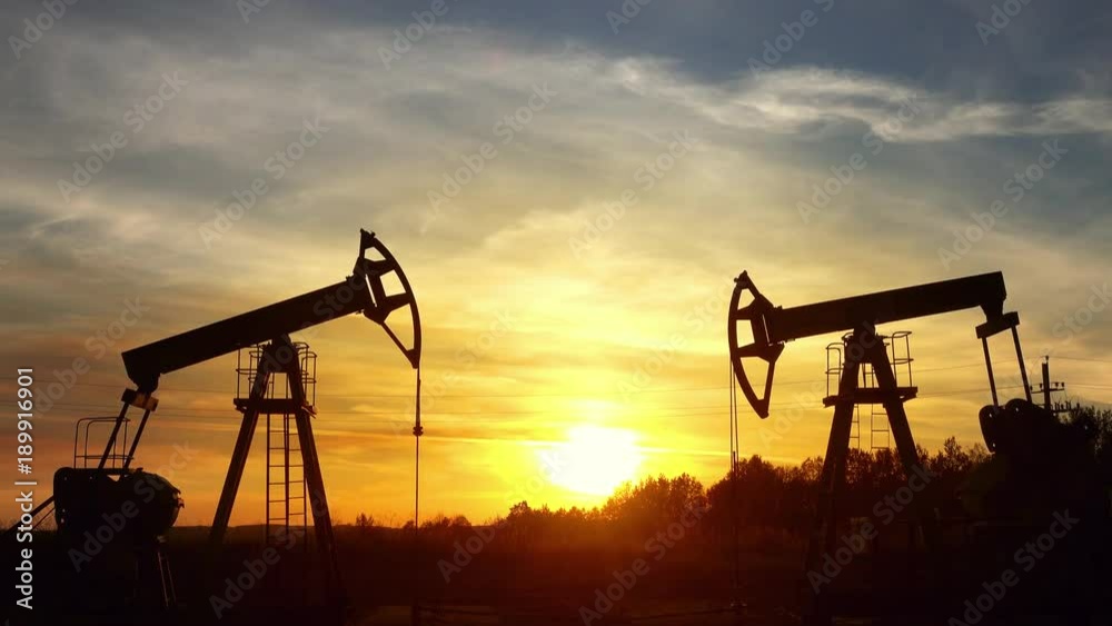 working oil pumps silhouette against sunset, 4k
working oil pumps silhouette against sunset, 4k