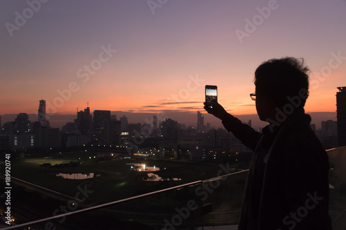 Dark scene of man who is taking a photo