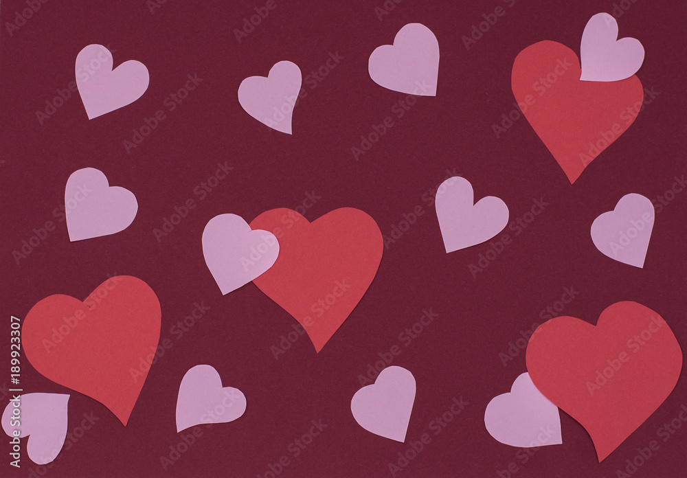 handmade hearts from paper on a red background