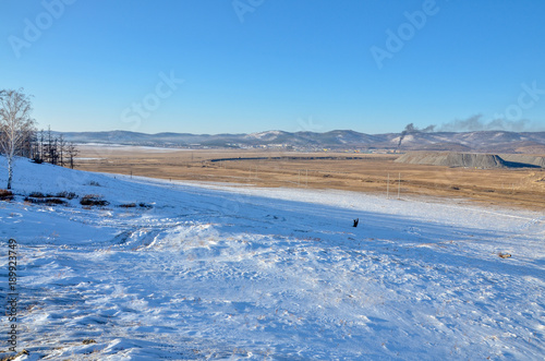 panoramic view of coal mining town Sagan Nur and giant gob piles on the slopes of southern Buryatia hills  Republic of Buryatia  Russia 