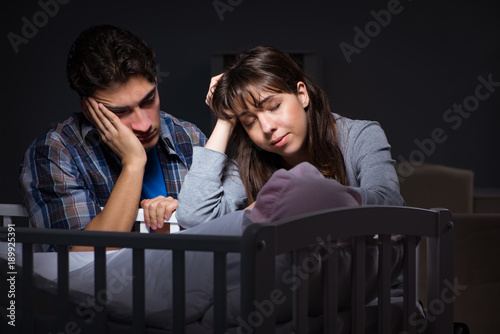 Fotografie Young parents sleepless with newborn baby at night