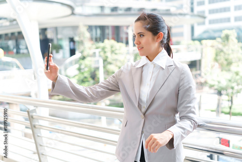 Portrait beautiful business woman take selfie with smartphone at outdoors. concept of communication and video call. photo