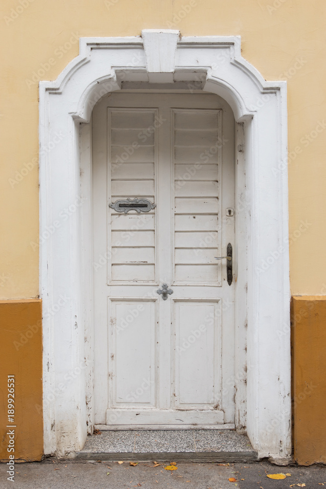 Fototapeta premium Front view of old rustic white front door