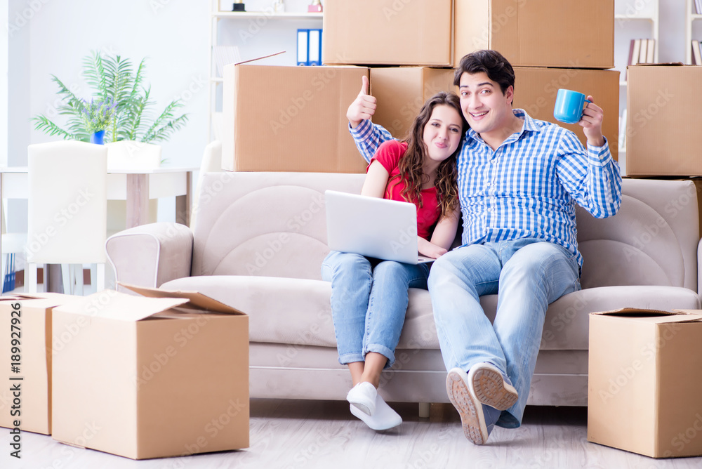 Young pair moving in to new house with boxes Young pair moving in to new house with boxes