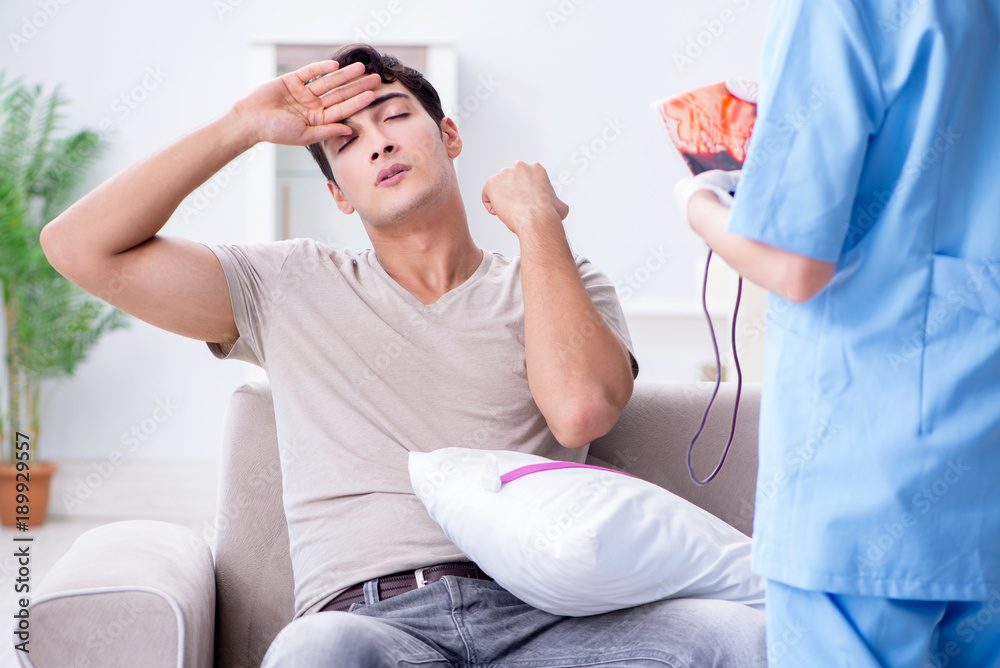 Obraz premium Patient getting blood transfusion in hospital clinic