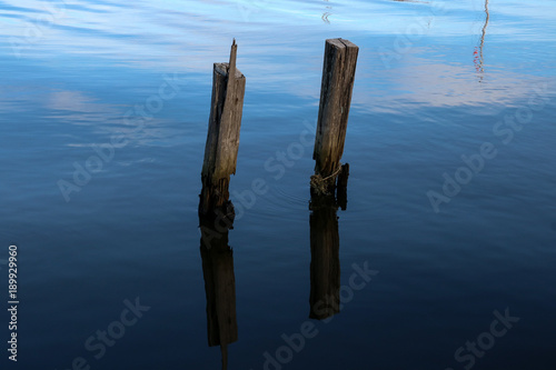 Old Wooden Jetty Pillars Protruding from the Sea © bigal04uk