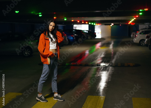 Young fashionable woman hipster walking in the city and parking